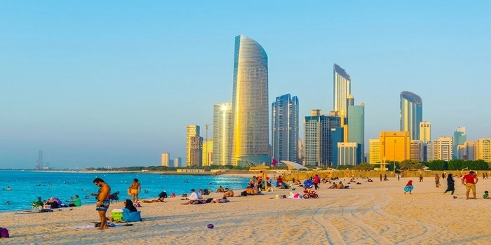 Abu Dhabi beach with white sand and calm blue water along the Corniche waterfront