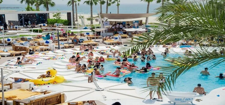 Nikki Beach Dubai luxury beach club with ocean view, white loungers and palm-lined coastline