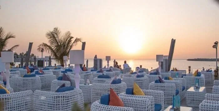 Smoky Beach Dubai beachfront lounge with shisha, food, and sea view at sunset